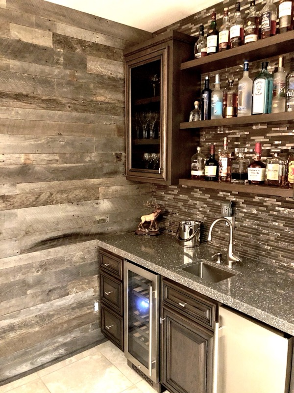 Custom bar — cabinets, granite top, and tile backsplash